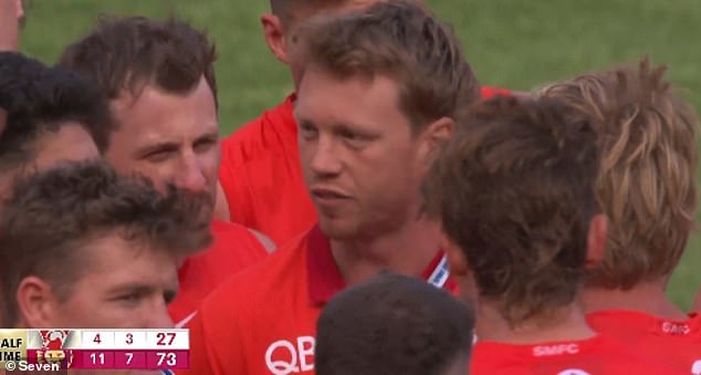 Injured Swans captain Callum Mills (pictured center) was spotted in the middle of the MCG laying down the law on his teammates at half-time after a poor performance in the AFL grand final