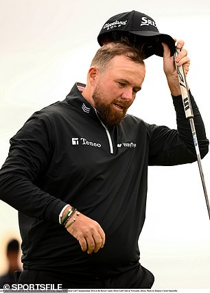 Shane Lowry has set his sights on a Sunday showdown with his friend Rory McIlroy (right)