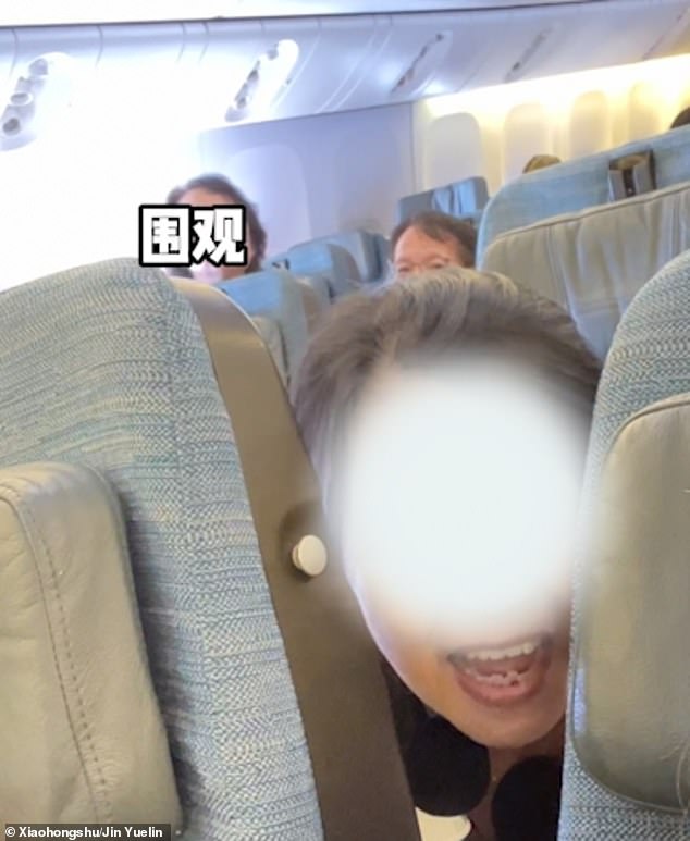 Footage shows the middle-aged couple (pictured) asking the woman to move her seat upright on the Cathay Pacific flight from Hong Kong to London on September 17 because it was blocking their view of the screen, but the passenger refused.