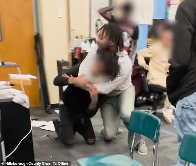 Shocking footage captured the moment a high school teacher put a student in a chokehold as children begged him to stop