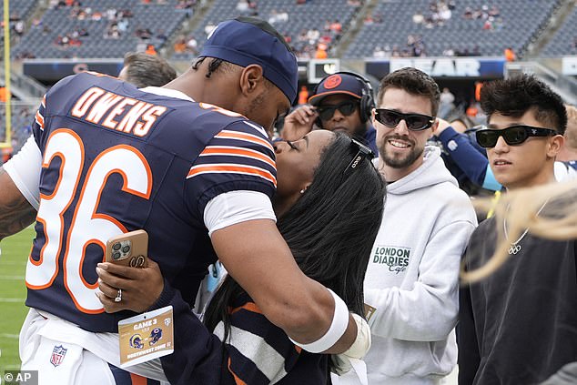 Simone Biles kisses her husband Jonathan Owens on the sidelines in Chicago on Sunday