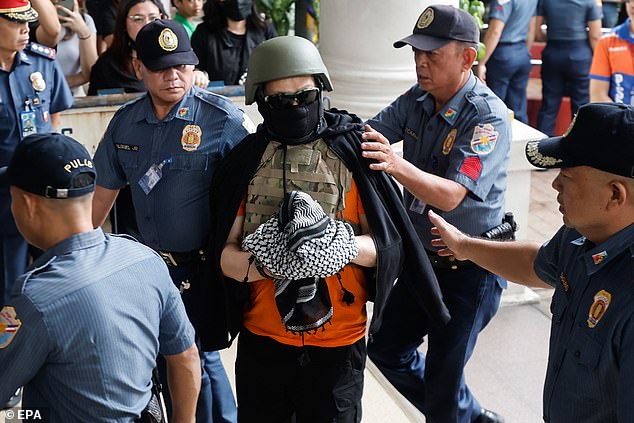 Filipino televangelist Apollo Quiboloy (center) arrives at a courthouse for his scheduled arraignment in Pasig City, Metro Manila, Philippines