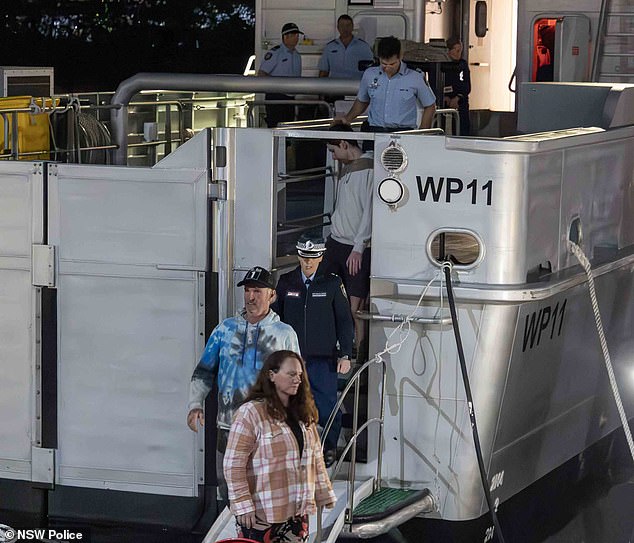 Lisa, 48, and Brett, 60, arrived in Sydney at around 6.30pm on Tuesday evening. The two sailors thanked their many rescuers and said they felt 'safe' (the pair are pictured disembarking from the NSW Police ship Nemesis)