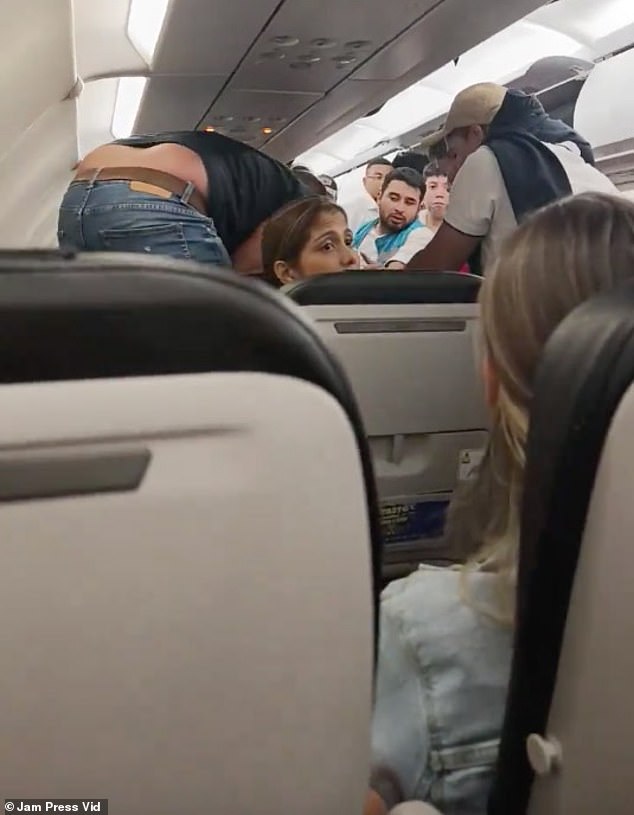 A flight attendant tries to calm passengers over the intercom as the plane is rocked by strong winds. The scary scenes were filmed on Avianca Airlines Flight 8586