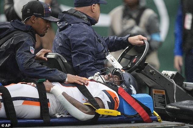 Tyler Badie is taken off the field at MetLife Stadium after collapsing on the sideline