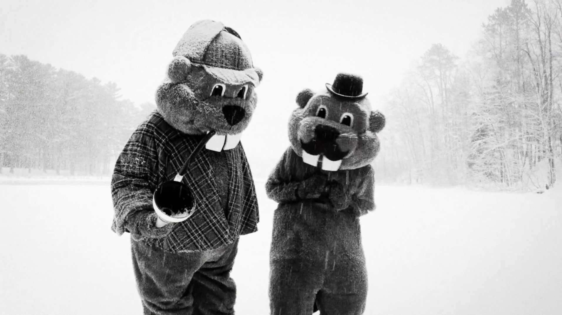 Two people in mascot-sized beaver costumes wear Sherlock and Watson outfits in the snow in Hundreds of Beavers