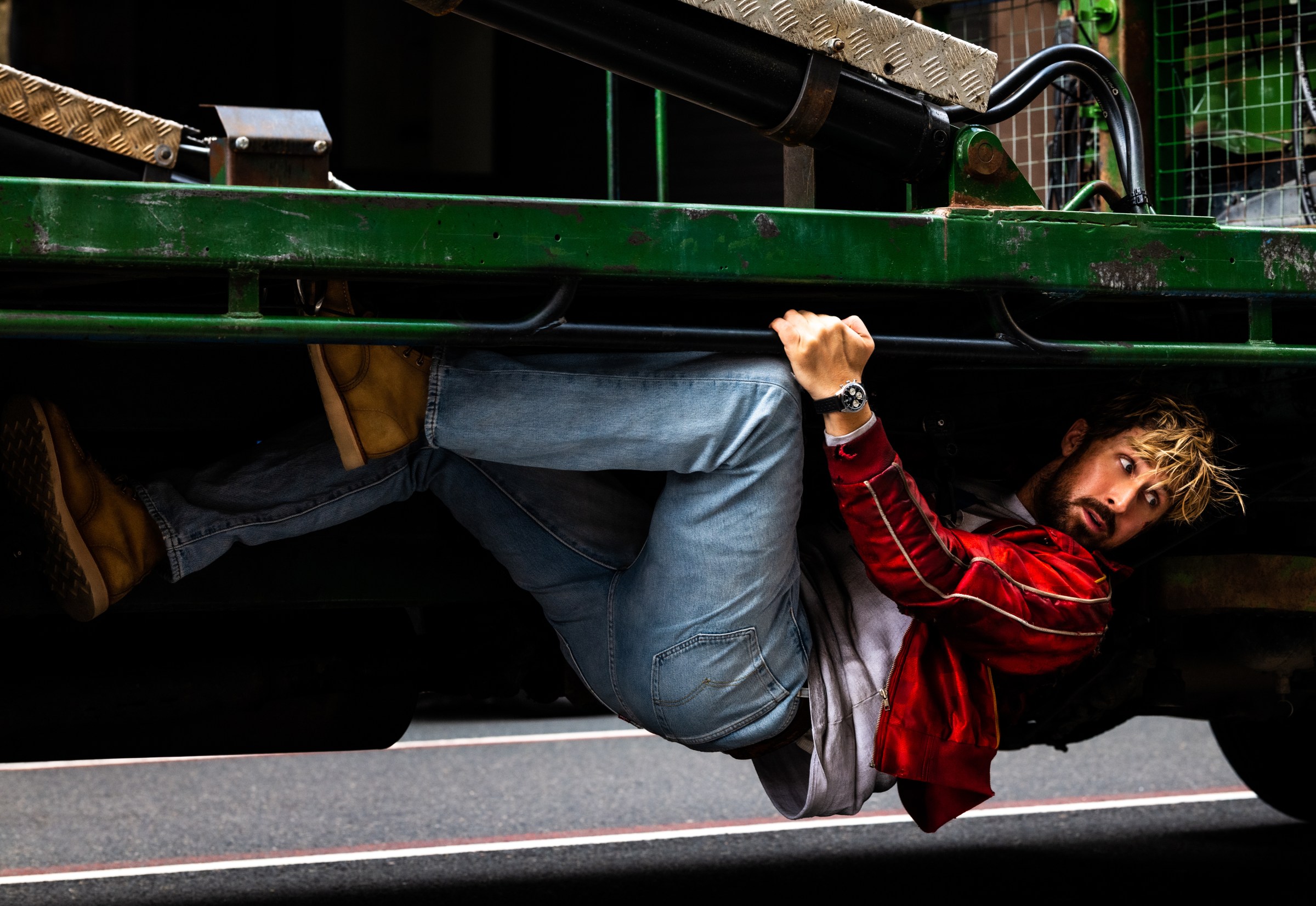 Ryan Gosling hangs from the bottom of a garbage truck in The Fall Guy