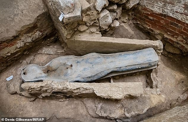 The coffin found beneath Notre-Dame Cathedral after the devastating fire of 2019 has been identified as belonging to 16th-century Frenchman Joachim du Bellay. Pictured is the lead sarcophagus of the previously 'unknown' individual, surrounded by heating ducts from the 19th century