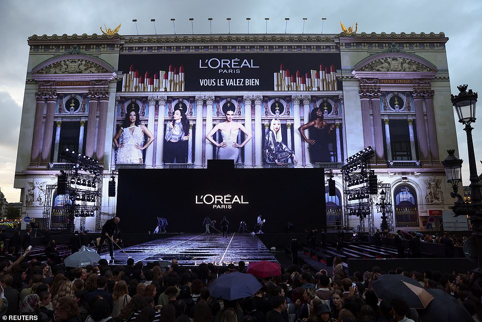 Torrential rain threatened to turn the launch of Paris Fashion Week into a French farce on Monday, but luckily for L'Oréal their extravagant opening show was unaffected by the storm that raged outside the Opera National de Paris (pictured)