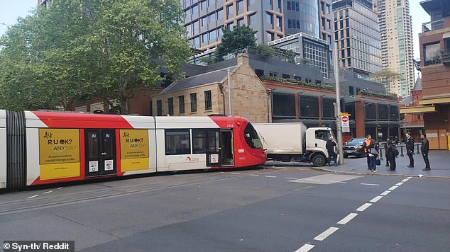 The truck driver was treated for minor injuries after the crash at the intersection of Pitt and Hay Street in Haymarket in Sydney's CBD (pictured)