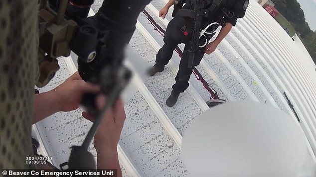 Trump shooter Thomas Matthew Crooks is seen dead on a roof in chilling new video taken moments after the assassination attempt