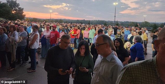 Nearly 6,000 event attendees wait outside as the interview between Tucker Carlson and JD Vance was delayed two hours over claims there were only eight metal detectors to screen everyone