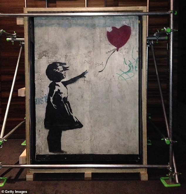 Larry Fraser, 47, and James Love, 53, have been charged with burglary after Banksy's Girl with Balloon (pictured) was stolen from a London gallery on New Cavendish Street