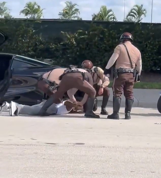 Hill was pinned to the ground and handcuffed by police as he walked to the stadium, leading to astonishing scenes