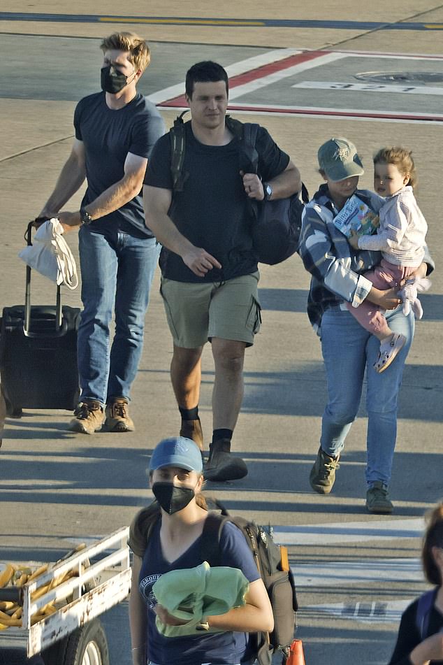 The Irwin family looked close-knit as they left the airport on Monday, two days before the 18th anniversary of Steve Irwin's death (pictured: Terri, Robert and Bindi with Chandler Powell)