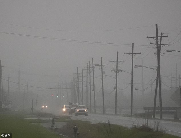 Cars drive through rain bands along Peter Rd., just outside New Orleans, ahead of Tropical Storm Francine, in Harvey, Louisiana on Tuesday.