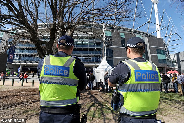 Members of Victoria Police stand outside the MCG during the AFL Grand Final match between the Hawthorn Hawks and Sydney Swans at the MCG in Melbourne, Saturday, September 27, 2014. (AAP Image/Joe Castro) NO ARCHIVING, FOR EDITORIAL USE ONLY