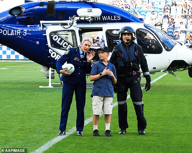 Heroic police officer Amy Scott made a dramatic entrance on the first day of emergency rounds - arriving by helicopter. With her was Jack Lucas, who lost his police officer father last year. Together they delivered the 'missing' ball for match day (pictured)