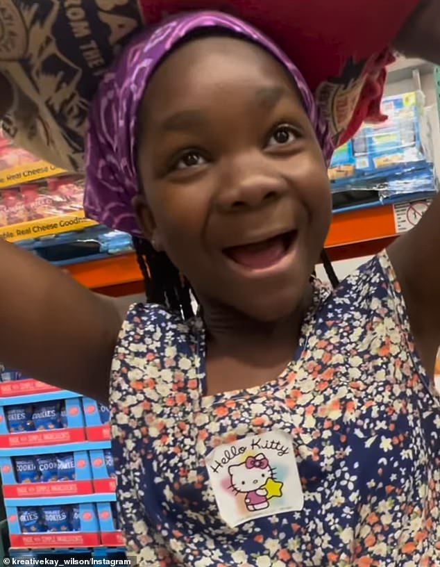 A white mother posted a video in which she can be heard telling her nine-year-old adopted black daughter Wella to carry a bag of rice on her head because 'it's in your blood'