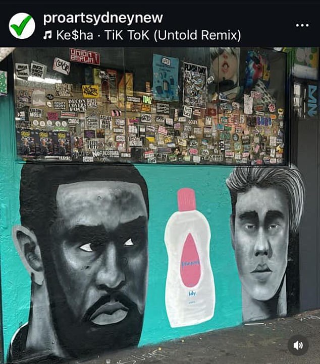 Pro Art Sydney mural showing Sean 'Diddy' Combs looking wide-eyed at Justin Bieber with a bottle of baby oil between them