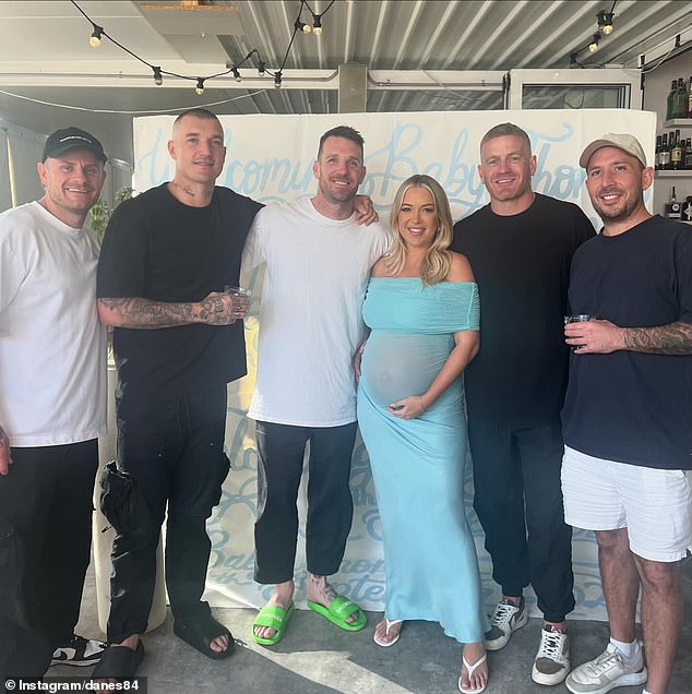 Dustin Martin (second left) is pictured with Collingwood Great Dane (third left) on the Gold Coast amid rumours he will play for the Suns next season