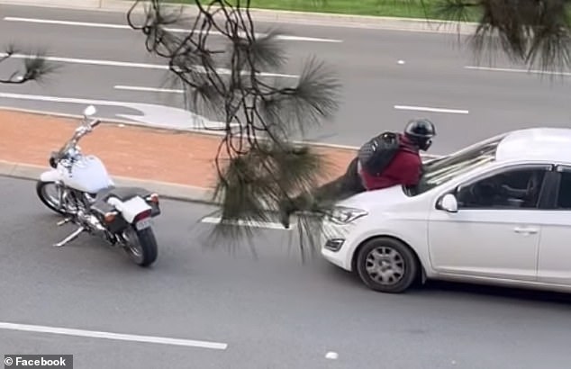 A motorcyclist in Canberra attempted to block a car by parking his bike in front of the vehicle and jumping on the bonnet