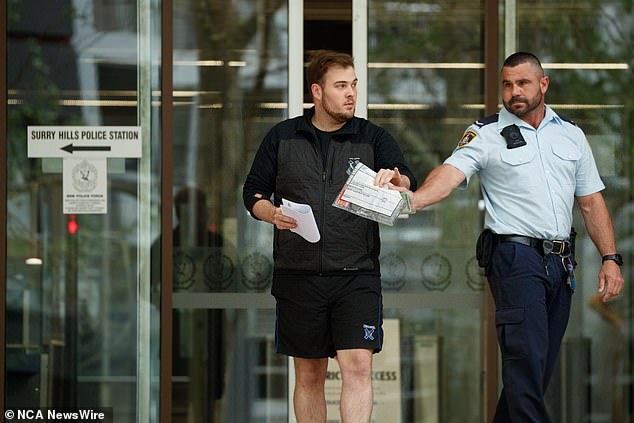 Gulson is seen leaving Surry Hills police station in his Knox teacher's uniform