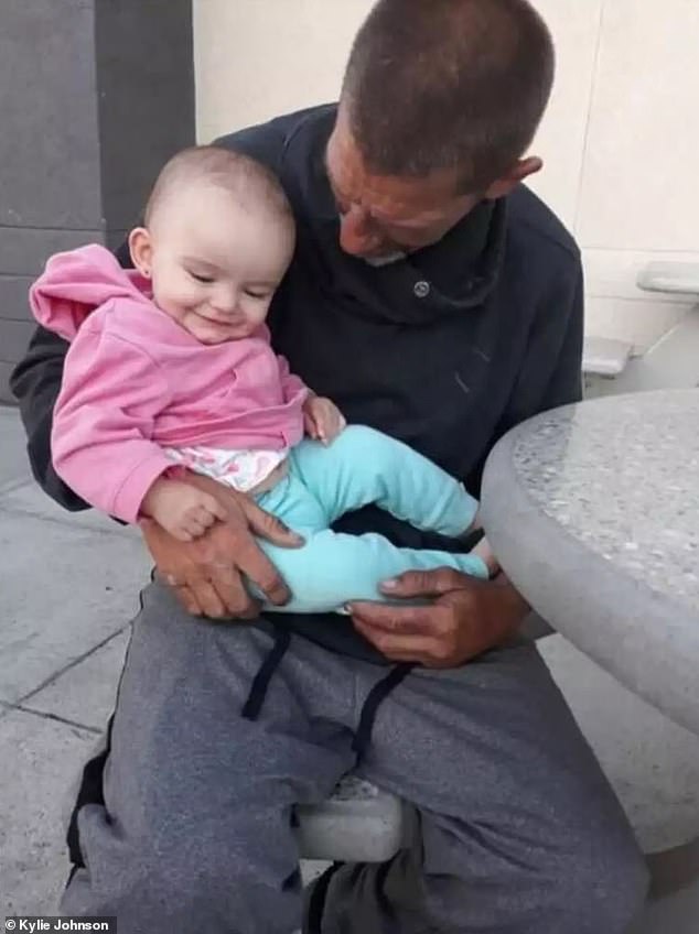 James Robinson held his granddaughter when his family found him after three years of thinking he was dead