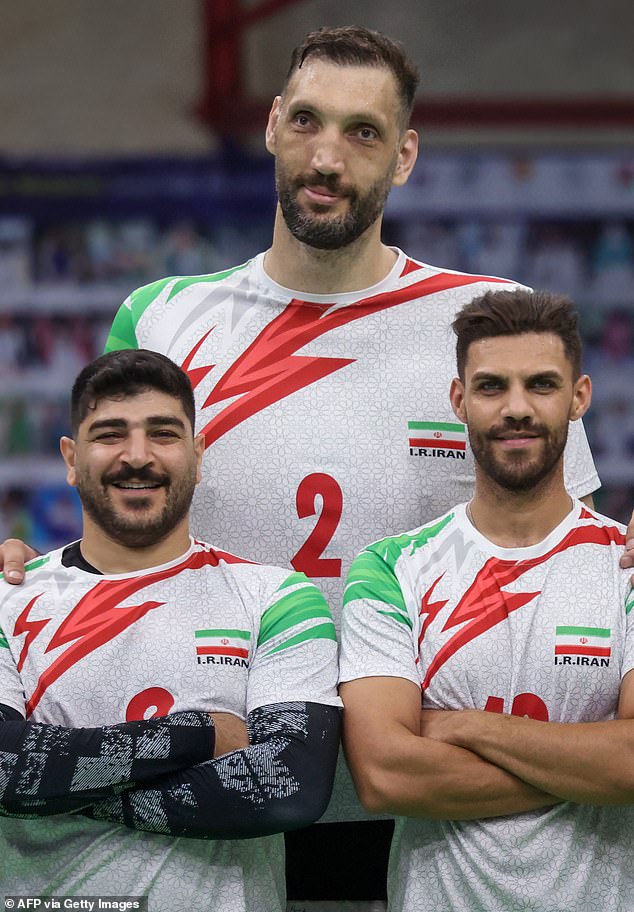 The world's second tallest man, Morteza Merhzad (center), is forced to sleep on the floor in the athletes' village at the Paralympic Games