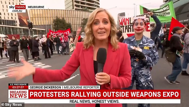 The woman (pictured right), who calls herself Nikki on social media, was one of about 1,200 anti-war protesters who gathered at the Land Forces 2024 arms fair