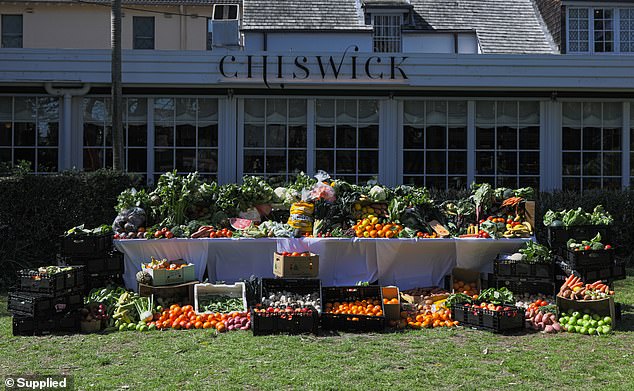 Every year, Australian households waste up to $3,000, or 312kg per person, by throwing away unwanted food. Pictured: 780kg of food dumped on the lawn at Chiswick Restaurant in Sydney to highlight Australia's alarming food waste crisis