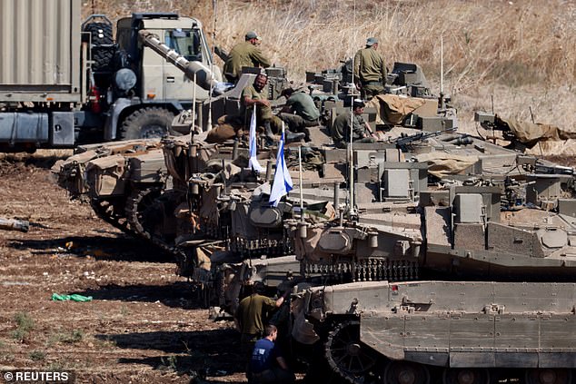 Israeli armored military vehicles are lined up in formation, amid cross-border hostilities between Hezbollah and Israel, in northern Israel, September 30, 2024, amid reports of an 'imminent' invasion