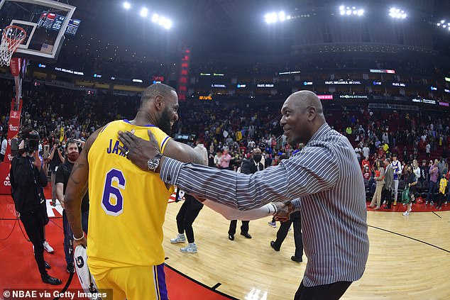 Mutombo hugs Los Angeles Lakers icon LeBron James at the end of a game in 2021