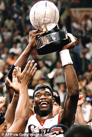 Mutombo holds up the Eastern Conference trophy after winning it with the 76ers in 2001