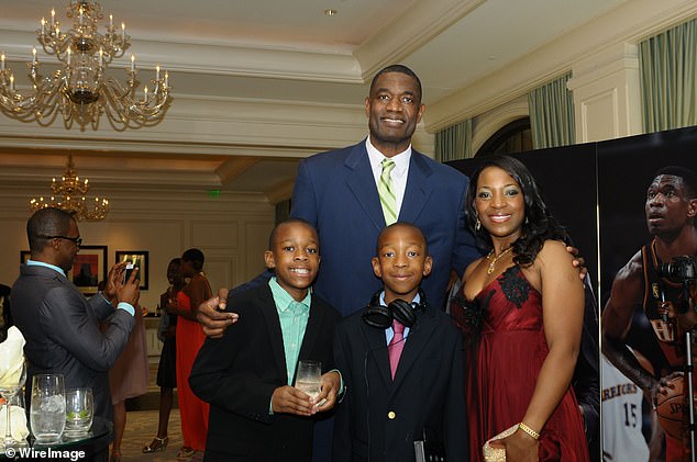 Mutombo poses with his wife Rose and two sons, JJ and Ryan, at a gala in Atlanta in 2012