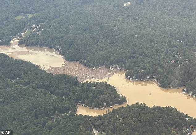 Storm debris is seen in the waters of Lake Lure in Rutherford County, near the village of Chimney Rock, seen from the air Monday from a North Carolina National Guard aircraft