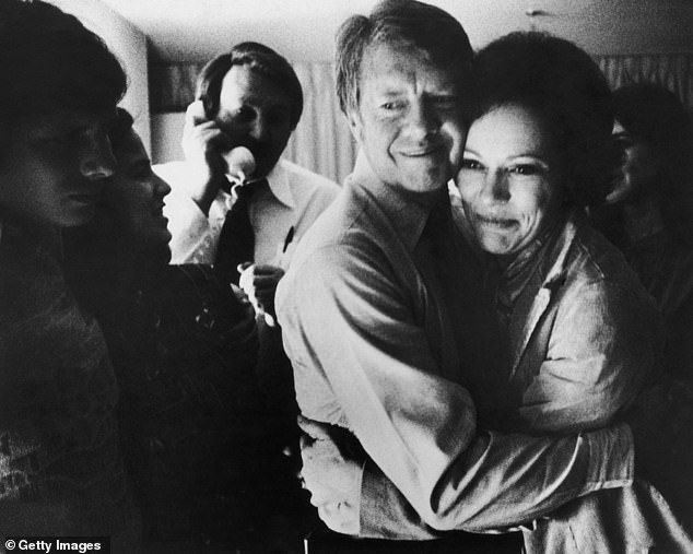 Democratic presidential candidate Jimmy Carter embraces his wife Rosalynn after receiving the latest news of his victory in the national general election on November 2, 1976