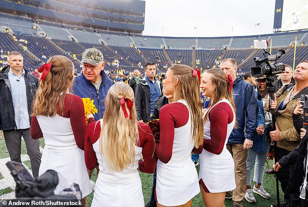 Tim Walz talks to cheerleaders during Saturday's football game