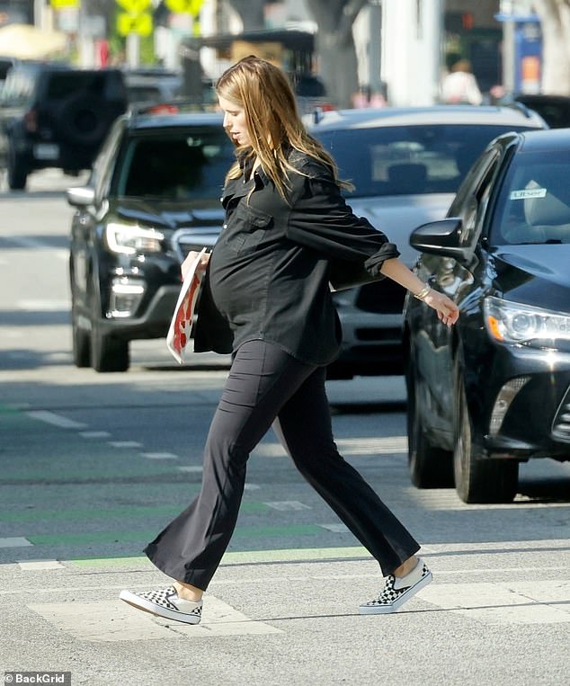 Katherine added some flair to her very pregnant look with a pair of classic black and white plaid Vans