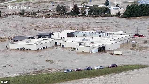 People are seen on the roof of Unicoi County Hospital in Erwin, Tennessee