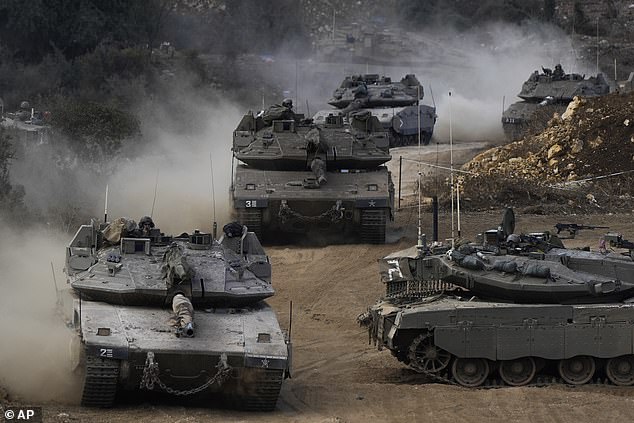 Israeli army tanks maneuver in a staging area in northern Israel, near the Israel-Lebanon border