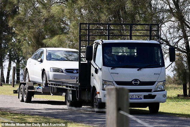 A truck carrying a white Holden sedan arrived at the property on Tuesday