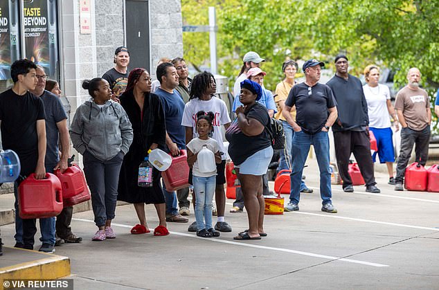 Asheville residents line up for gas at a gas station on Sunday