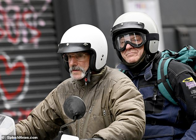 Daniel Day-Lewis (left) looked completely unrecognizable as he shot motorcycle scenes with actor Sean Bean in Manchester seven years after his retirement