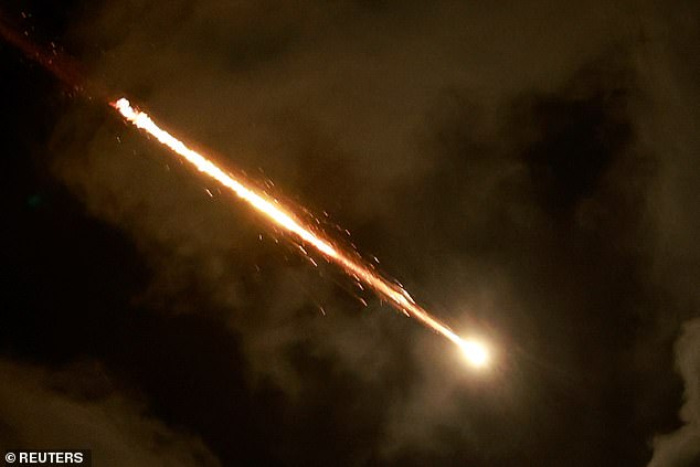 A rocket flies in the sky above Tel Aviv