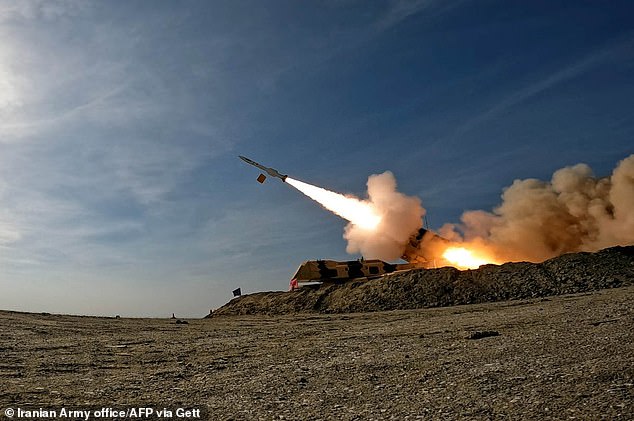 The US Embassy warned its staff in Israel to prepare to go to bomb shelters amid reports that Iran is planning an 'imminent' ballistic missile attack. The image shows an Iranian missile launched during an exercise earlier this year