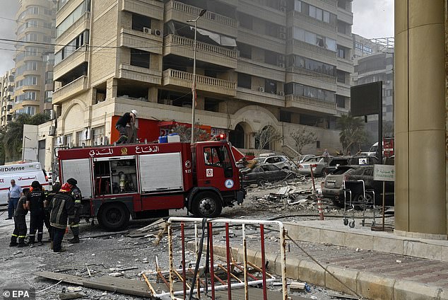 Rescuers in Beirut drive through the rubble of a building decimated by Israeli airstrikes