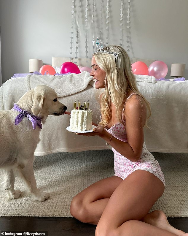 In one photo, she smiled as she sat on the floor and held a cake for her dog Roux