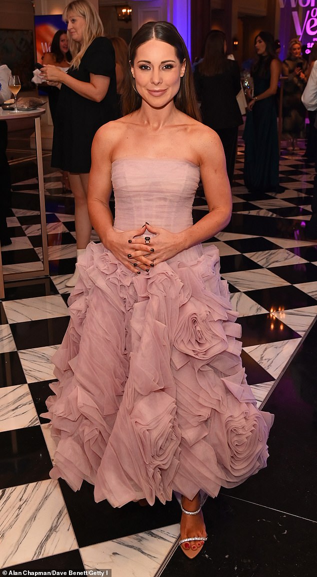 Meanwhile, Louise, 34, cut an elegant figure in a pale pink tulle midi dress with ruffles, complete with a corset-style bodice