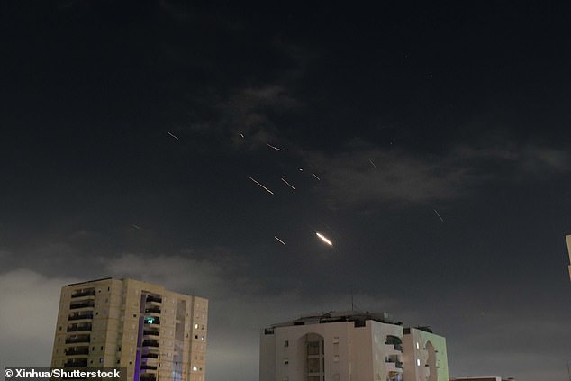 This photo, taken on April 14, 2024, shows flares from explosions in the skies over Tel Aviv as Israel's anti-missile system intercepts missiles and drones from Iran